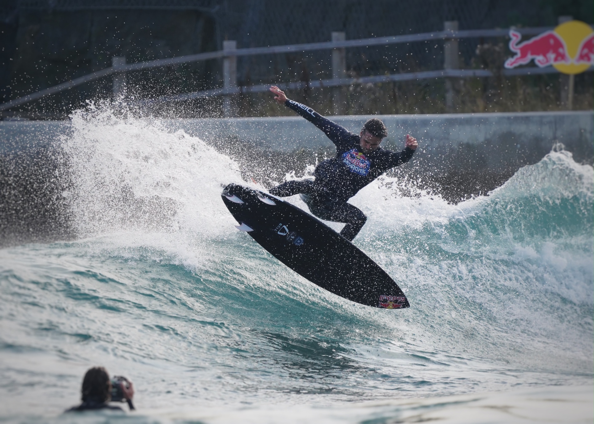 Surfer launching an air above the lip of the wave