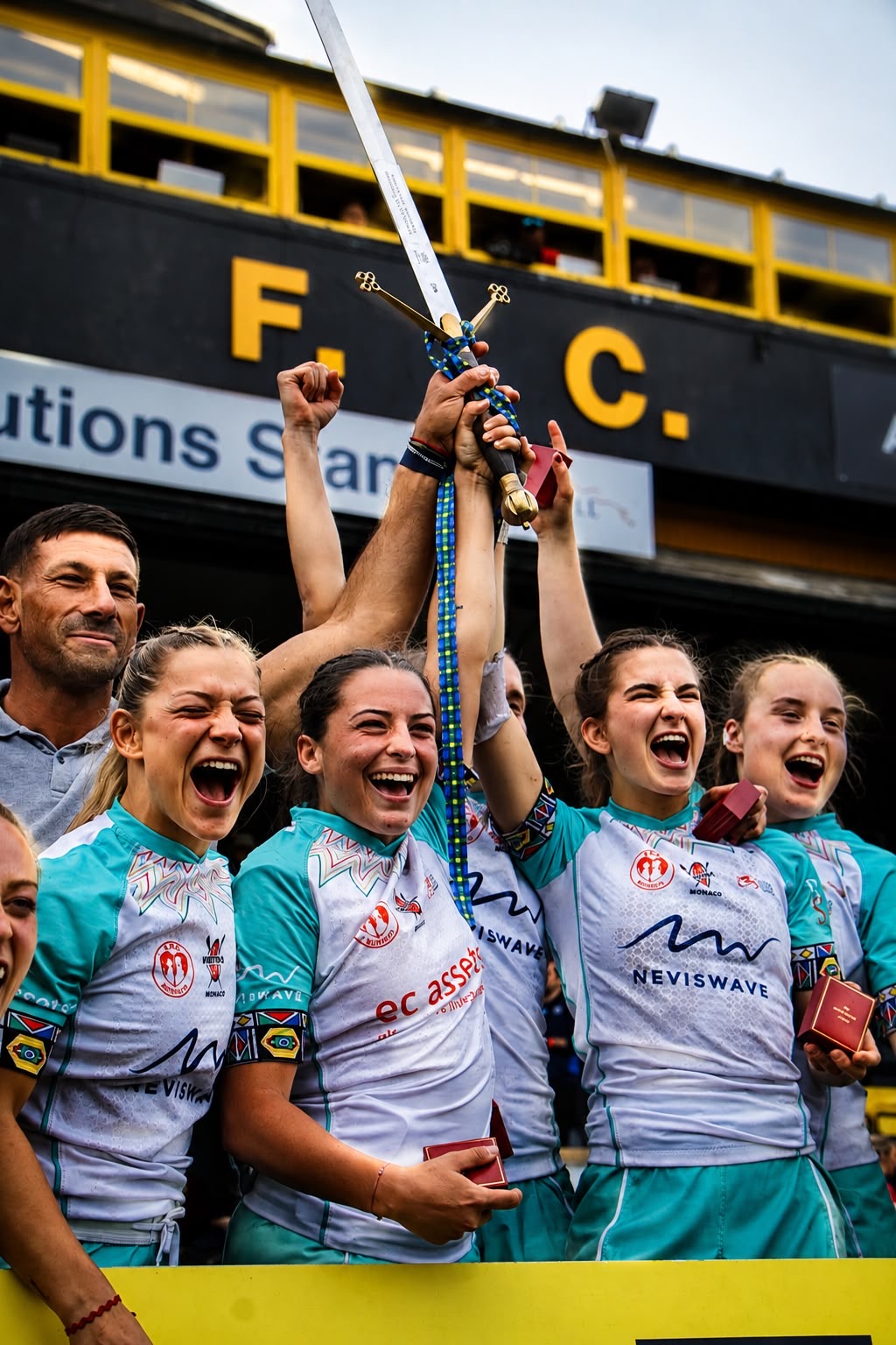 Four sevens players shouting in celebration as they raise the sword