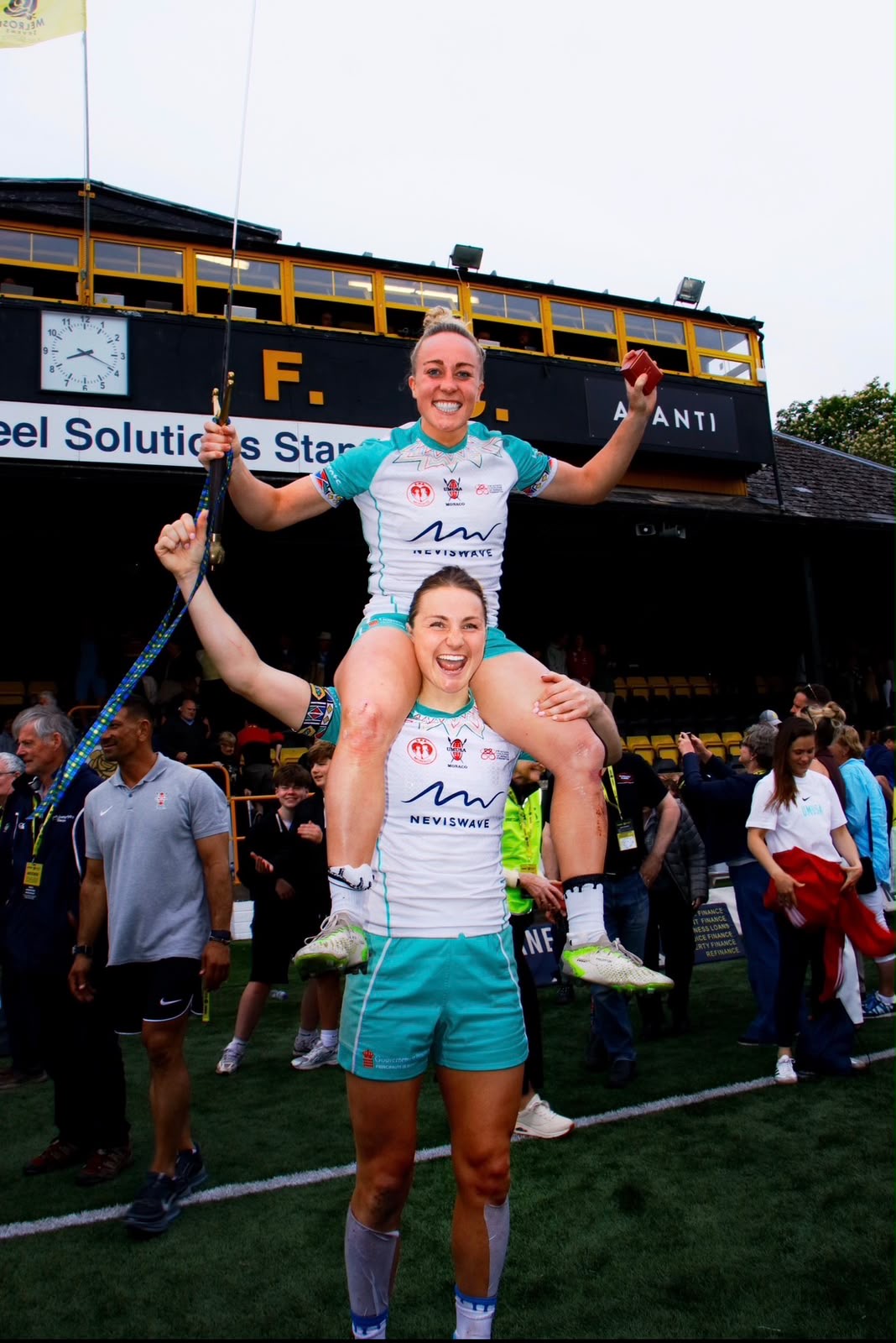 Sevens winners celebrating, one player lifted onto another's shoulders